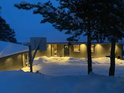 a building with snow in front of it at night at Ringåsen in Berg
