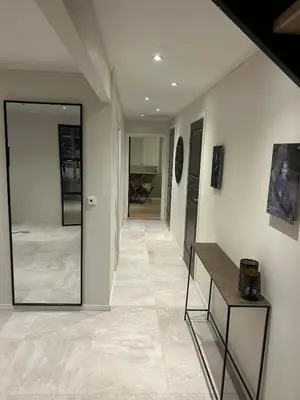 a hallway with white walls and a hallway with a mirror at Ringåsen in Berg
