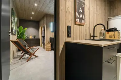 a kitchen with a counter and a sink and chairs at Family Cabin At The Foot Of Gaustatoppen in Rjukan