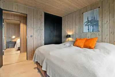 a bedroom with a large white bed with orange pillows at Family Cabin At The Foot Of Gaustatoppen in Rjukan