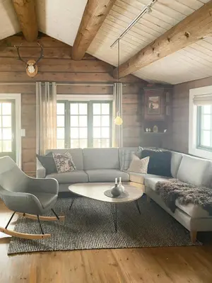 a living room with a couch and a table at Charming Log Cabin In Jøldalen in Rennebu