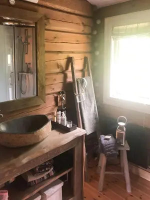a bathroom with a sink and a mirror at Charming Log Cabin In Jøldalen in Rennebu