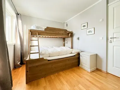 a bedroom with a bunk bed with a ladder at Big And Modern Apartment At Beitostølen in Beitostøl