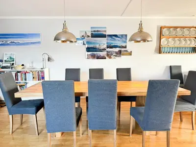 a dining room with a wooden table and blue chairs at Big And Modern Apartment At Beitostølen in Beitostøl