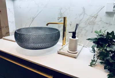 a bathroom counter with a sink and a bowl at Elegant Three-Bedroom Apartment with Stunning Sea Views - Limited availability - Secure your booking for Summer in Ålesund