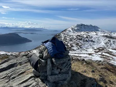 a back pack sitting on top of a mountain at Apartment by the fjord, with boat and jacuzzi included in Larsnes