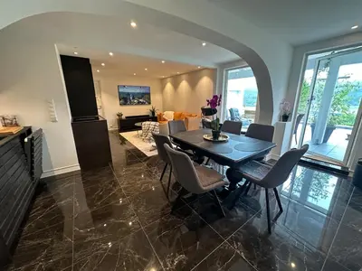a dining room with a table and chairs at Apartment by the fjord, with boat and jacuzzi included in Larsnes