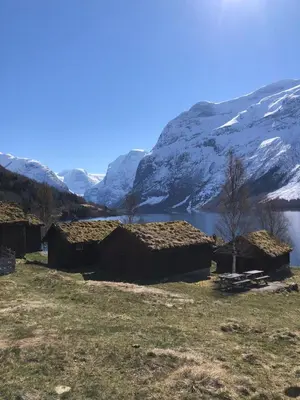 a group of huts in front of a mountain at Lovely apartment in beautiful Loen in Loen