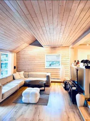 a living room with a couch and a table at 5 room apartment for Ski-World Championship in Trondheim