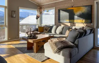 a living room with a couch and a table at Stunning Home In Bjorli With Wifi in Bjorli