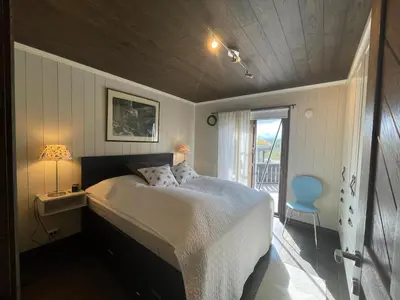 a bedroom with a bed and a table and a chair at Mountain Retreat Near Hiking And Skiing in Beitostøl