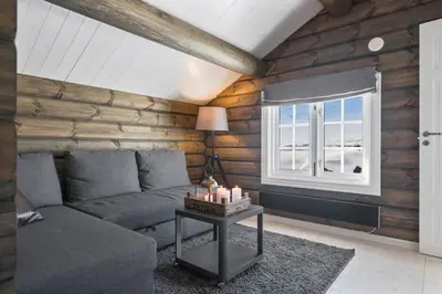 a living room with a couch and a window at New Timber Lodge With Stunning Views And Comfort in Beitostøl