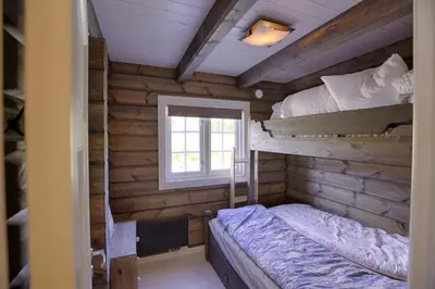 a bedroom with two bunk beds and a window at New Timber Lodge With Stunning Views And Comfort in Beitostøl