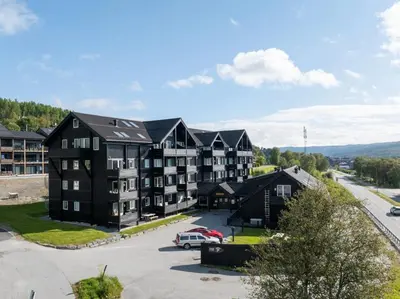 an aerial view of a building with a parking lot at Geilo Gaarden - Geilo sentrum in Geilo