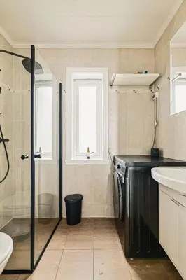 a bathroom with a shower and a sink and a toilet at DINBNB Apartment l Skansen funhouse - 400m to Bryggen Gym & Parking in Bergen