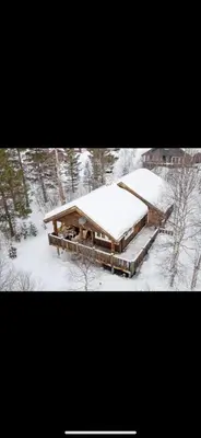 two pictures of a house covered in snow at Bjorli Mountain Cabin in Bjorli