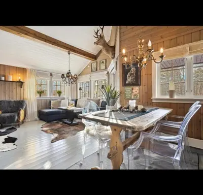 a living room with a table and a couch at Bjorli Mountain Cabin in Bjorli