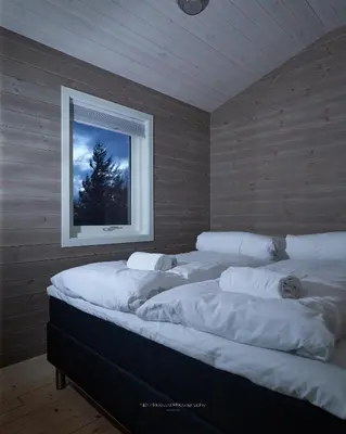 a room with four beds with a window at Rjånes Ferie og Konferansesenter in Ørsta