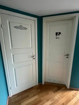 two doors in a room with green walls at Sokkelleilighet i enebolig i Ålesund nær stranden in Ålesund