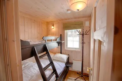 a room with two bunk beds and a window at Family-Friendly Cabin With Stunning Outdoor Access in Beitostøl