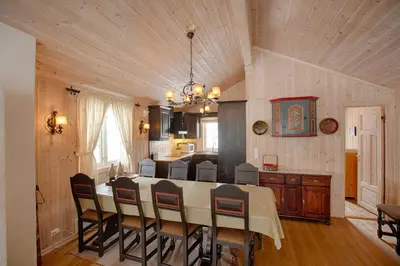 a kitchen and dining room with a table and chairs at Family-Friendly Cabin With Stunning Outdoor Access in Beitostøl