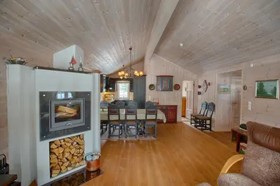 a living room and dining room with a fireplace at Family-Friendly Cabin With Stunning Outdoor Access in Beitostøl