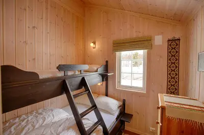 a bedroom with a bunk bed and a window at Family-Friendly Cabin With Stunning Outdoor Access in Beitostøl
