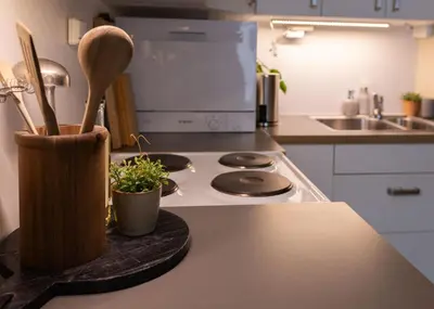 a kitchen with a counter top with a wooden knife block at Unique apartment in midtown in Trondheim