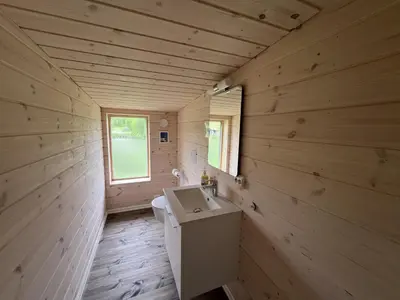 a wooden bathroom with a sink and a toilet at New Cozy Cabin By Ski Trails And Nature Paths in Beitostøl