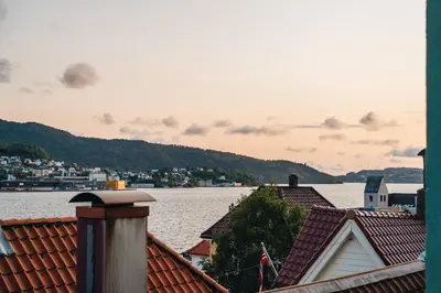 a view of the water from the roofs of houses at Bergens Nr1 smau I Enkel innsjekk I Sjøutsikt in Bergen
