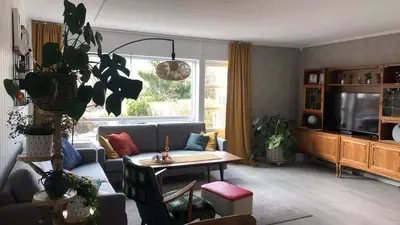 a living room with a couch and a table at Koselig rekkehus til leie under ski VM i Trondheim in Trondheim