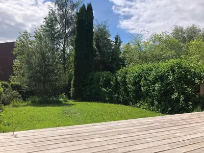 a view of a yard with a wooden deck at Koselig rekkehus til leie under ski VM i Trondheim in Trondheim