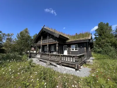 a log cabin with a grass roof at Relaxing Getaway With Sauna And Terrace in Beitostøl