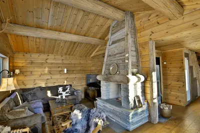 a living room of a log cabin with a fireplace at Relaxing Getaway With Sauna And Terrace in Beitostøl