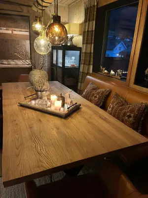 a wooden table with candles on it in a living room at Stylish apartment in Myrkdalen in Vossestrand