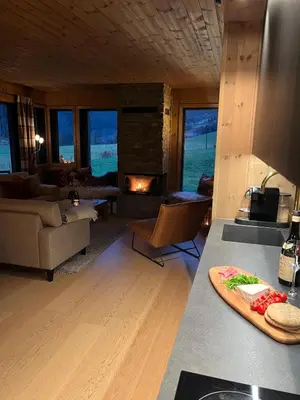 a kitchen with a living room with a fireplace at Stylish apartment in Myrkdalen in Vossestrand