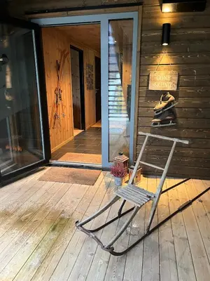 a chair sitting on the porch of a house at Stylish apartment in Myrkdalen in Vossestrand