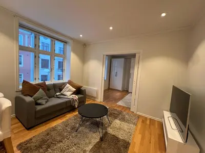 a living room with a couch and a tv at Apartment near City Center in Trondheim