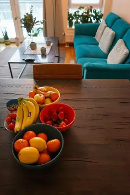 two bowls of fruit on a wooden table in a living room at Solrik leilighet på Byåsen in Trondheim