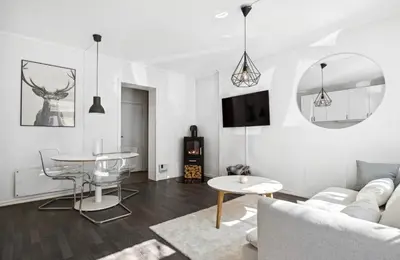 a living room with a couch and a table at Modern apartment close to the city center in Trondheim