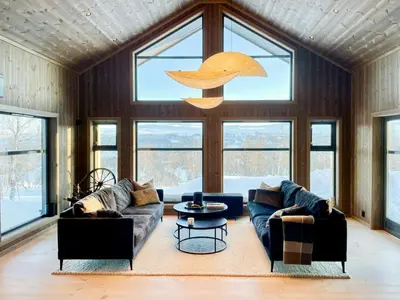 a living room with two couches and a table at Mountain Cabin At Hardangervidda in Uvdal