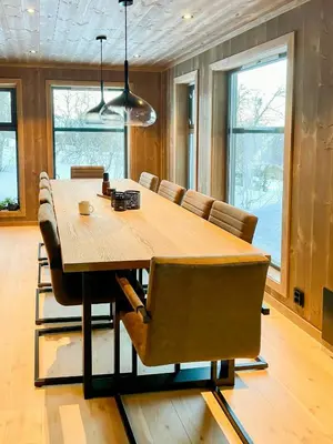 a dining room with a wooden table and chairs at Mountain Cabin At Hardangervidda in Uvdal