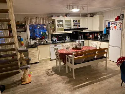 a kitchen with a table and a refrigerator at Hus til leie under VM 2025 in Ler