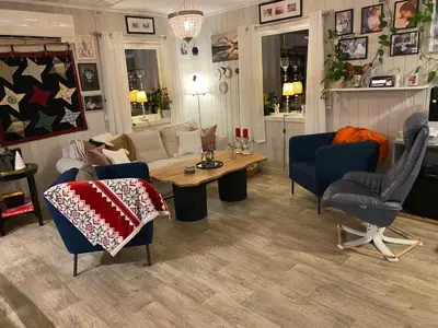 a living room with a couch and a table and chairs at Hus til leie under VM 2025 in Ler