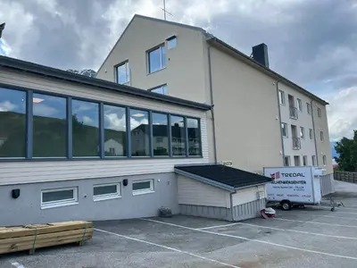 a large white building with a lot of windows at Åndalsnes house in Åndalsnes