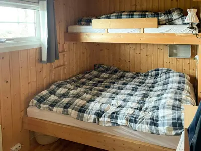 a bedroom with two bunk beds in a cabin at Family Cabin With Sun And Views At Ljøsheim in Mesnali