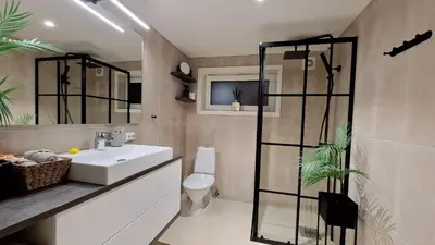 a bathroom with a sink and a toilet and a mirror at Rancho Apartment in Langevåg in Sula
