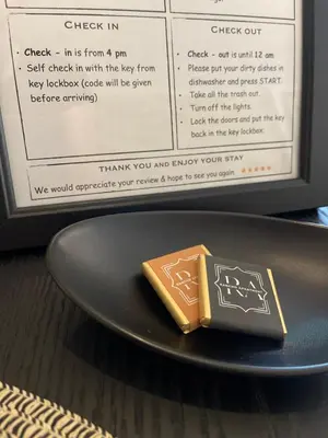 a chocolate bar on a plate on a table at Rancho Apartment in Langevåg in Sula
