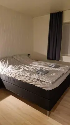 a large bed in a room with at Lom in Lom