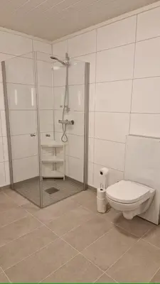 a bathroom with a shower and a toilet at Lom in Lom